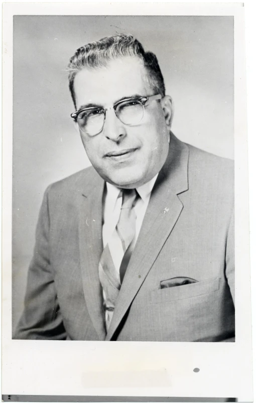 an old black and white portrait of a man in glasses