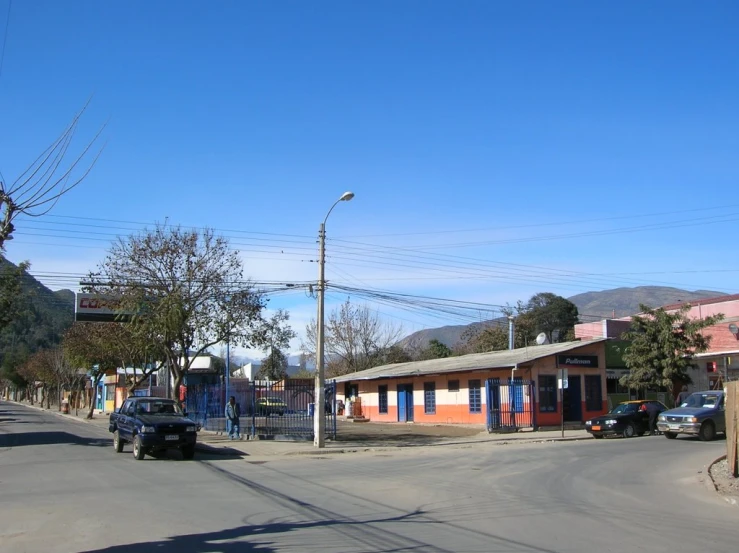 a truck on the road with two buildings in the background