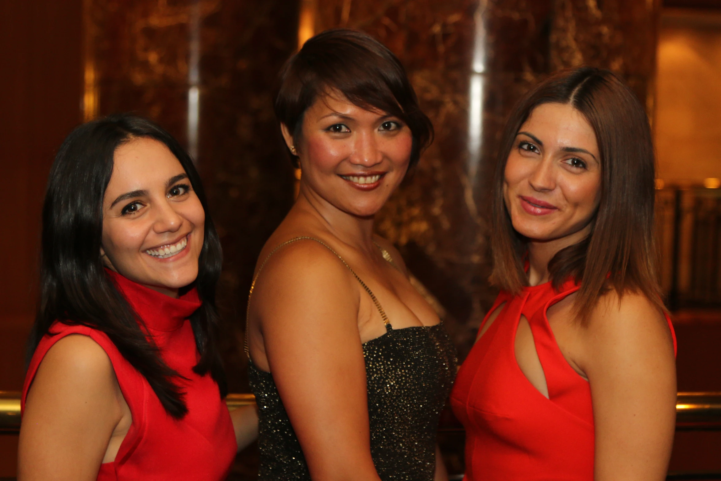 three beautiful women pose together for the camera