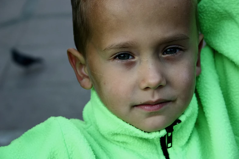 a  in green sweater is looking into the camera