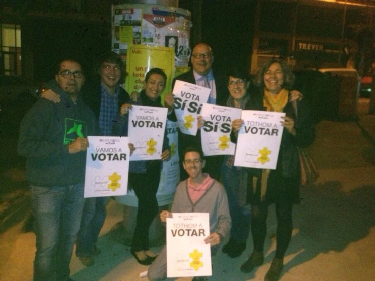 some people holding up signs in the street