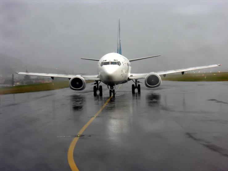 the airplane is about to take off on a rainy day