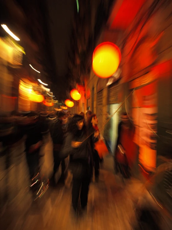 blurred blurry pograph of people in a busy shopping area