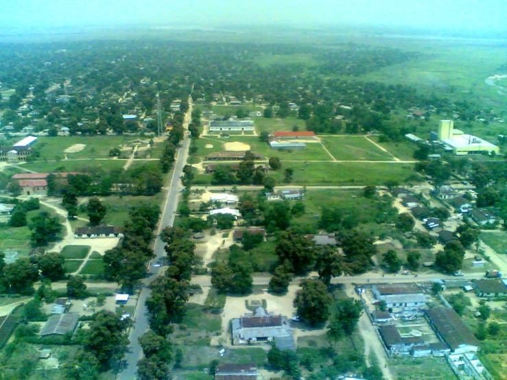 an aerial view shows houses, streets, trees and sky