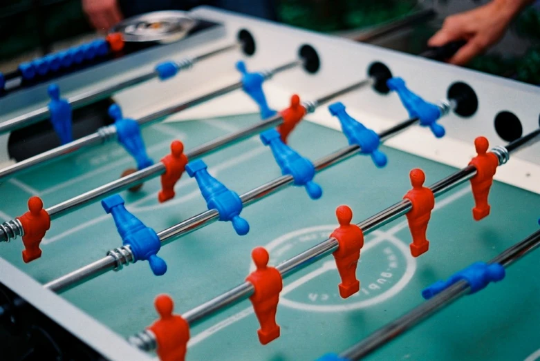 a foosball table with a lot of red and blue men in it