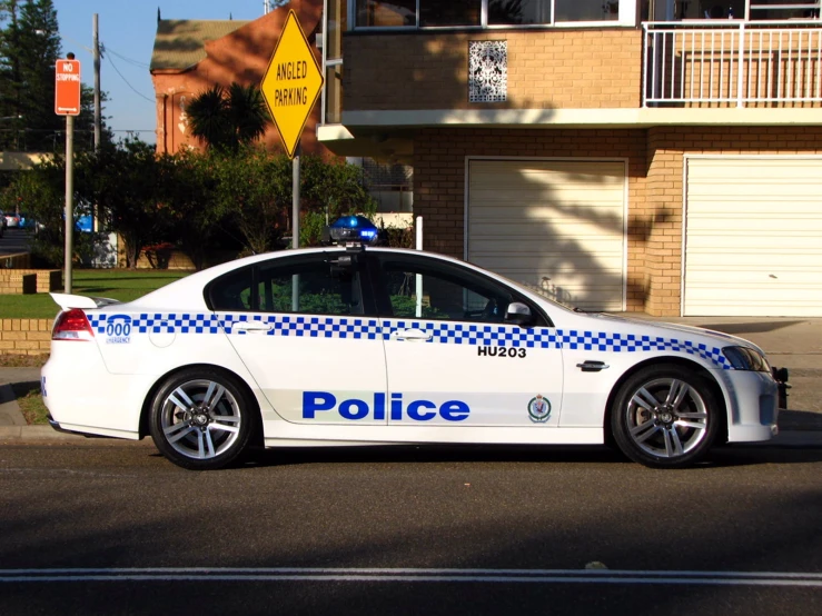 police car in street with sign on side