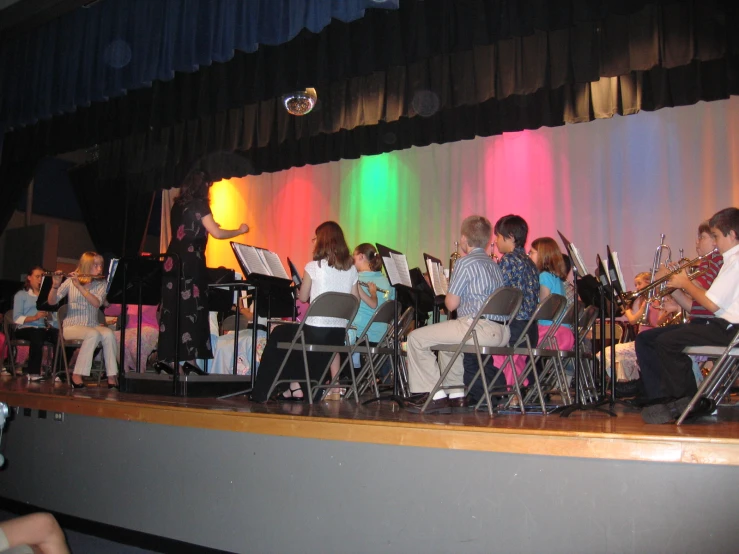 the people are performing in front of colorful lights