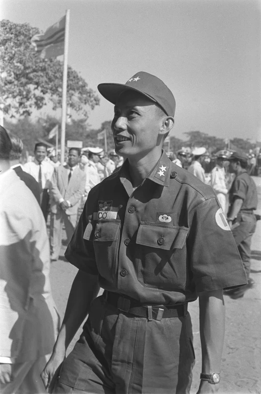 an older man in a military uniform smiles