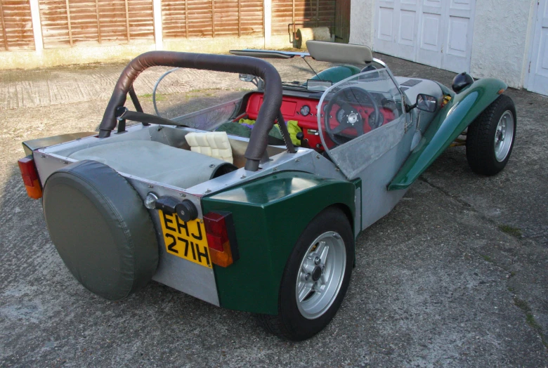 an empty race car sits in a driveway