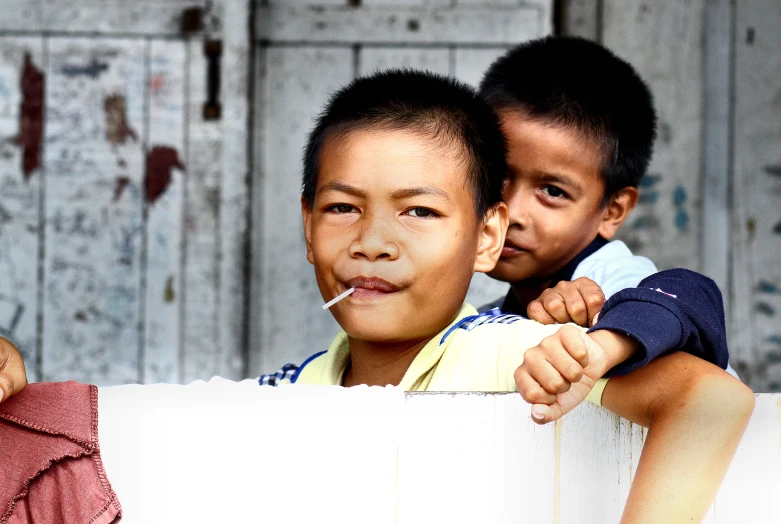 two young children look out over a large paper scroll