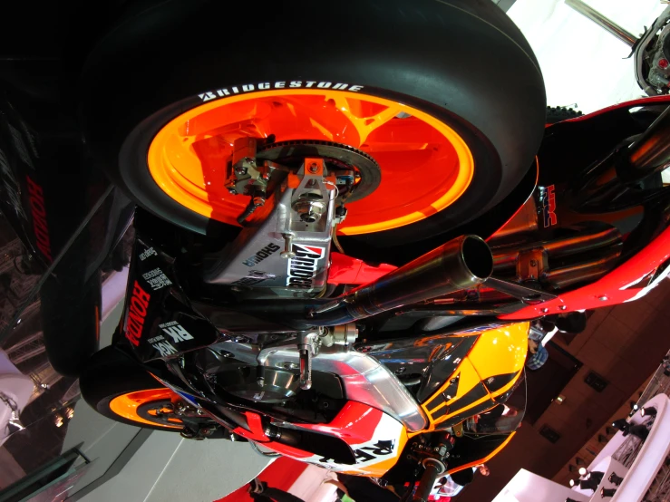 the wheel and orange tire of a motorbike