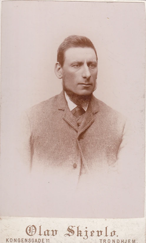 a young man in suit and tie with a serious look on his face