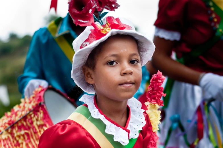 a young child in traditional costume looks on