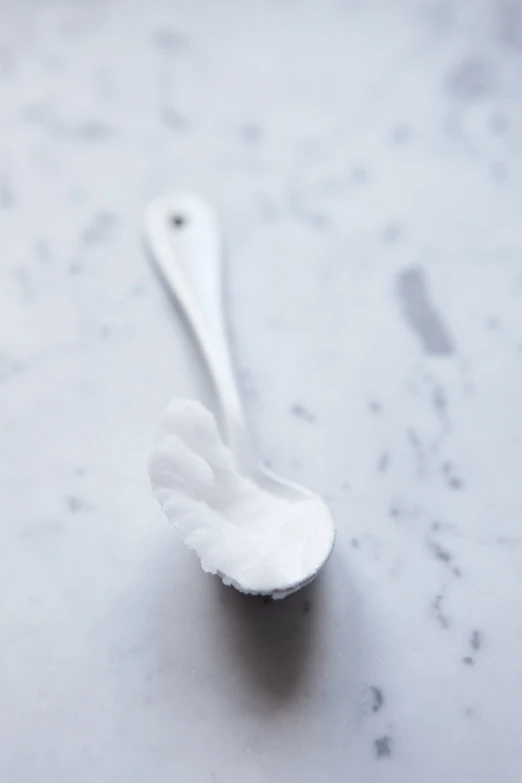 a toothbrush sits on a white table