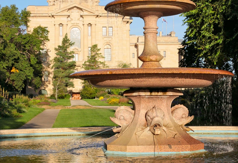 a fountain surrounded by some trees and houses