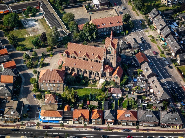 an aerial view of several brick buildings and a body of water