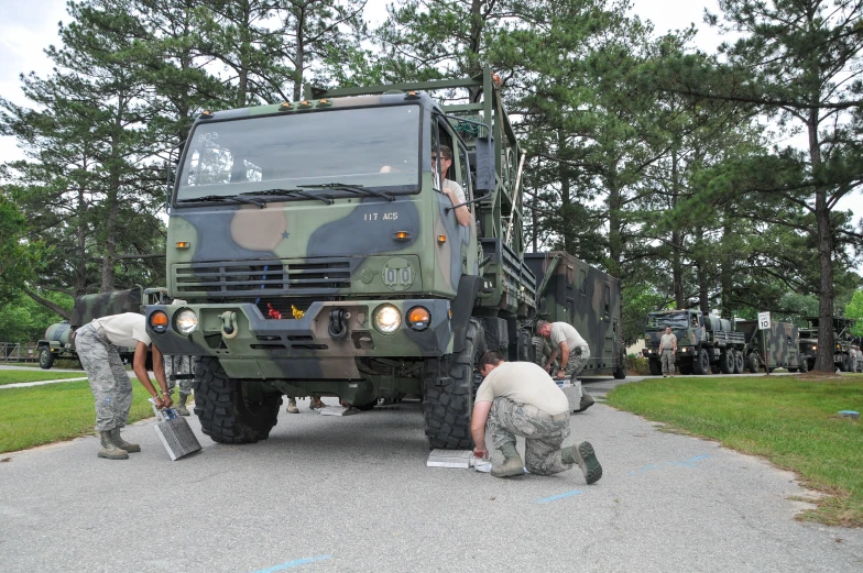 two soldiers and another military vehicle in the foreground