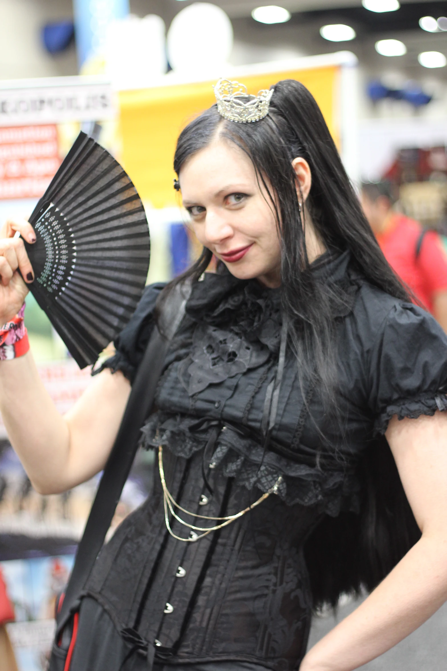 a woman in an exhibit holding a fan