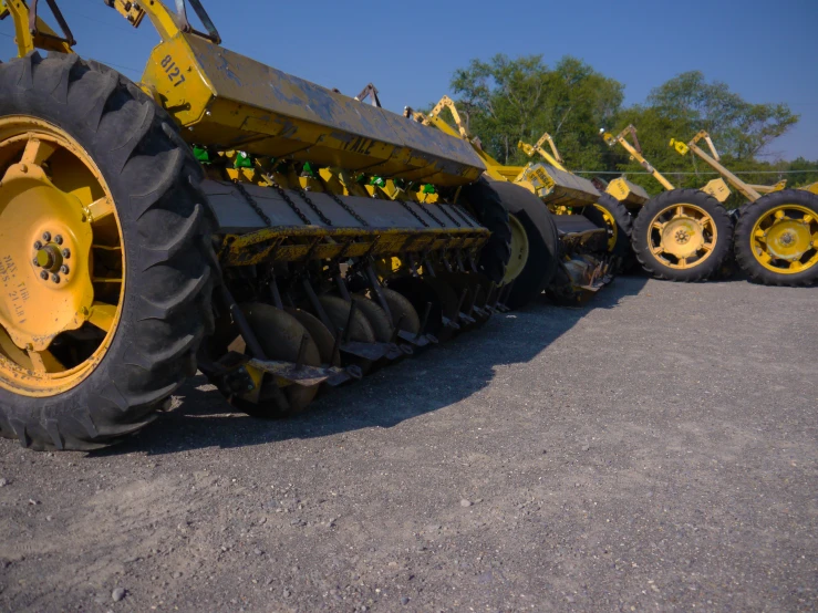 a large tractor with tires sitting in a parking lot