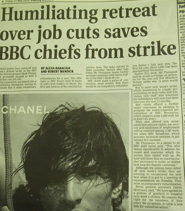a news paper has a man wearing a tie with long hair on top