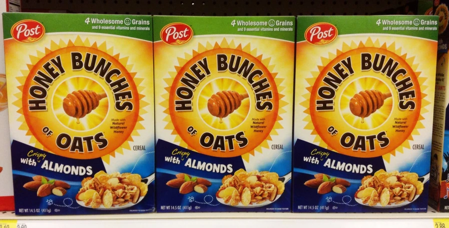 three boxes of honey bunches oats with almonds are displayed on the shelf in a store