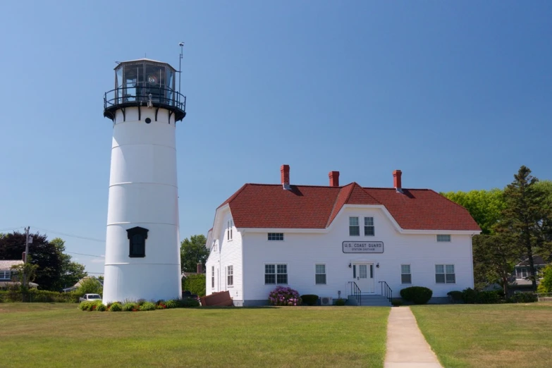 a large white building with a light tower behind it