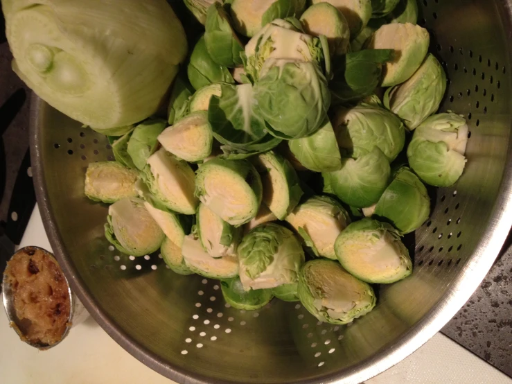 a metal basket filled with brussel sprouts