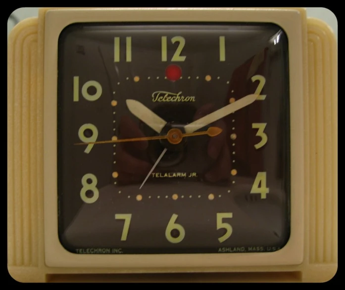 a brown and tan alarm clock is showing the time