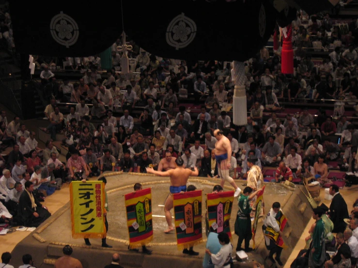 a group of people are standing around in a ring