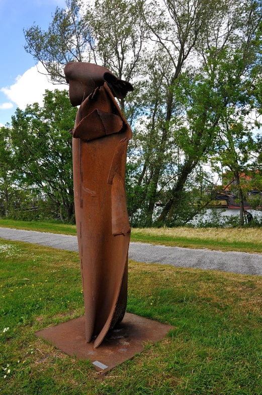 a wooden statue with an airplane and a bird sitting on top