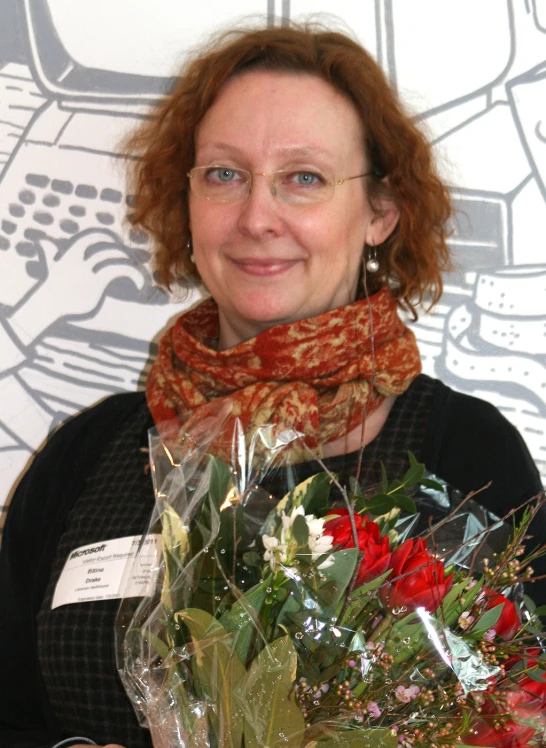 a woman with glasses and scarf holding a bouquet of flowers