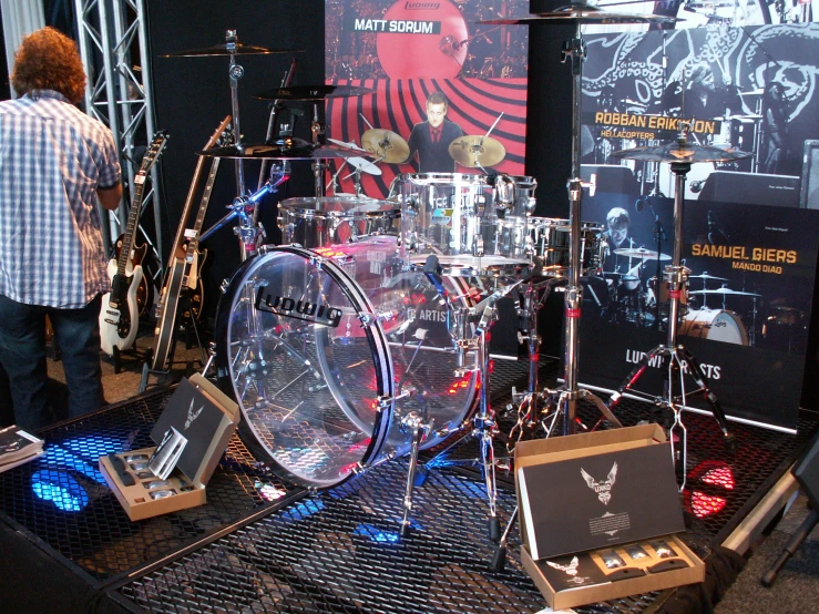 a rock band with drummers in front of a stage