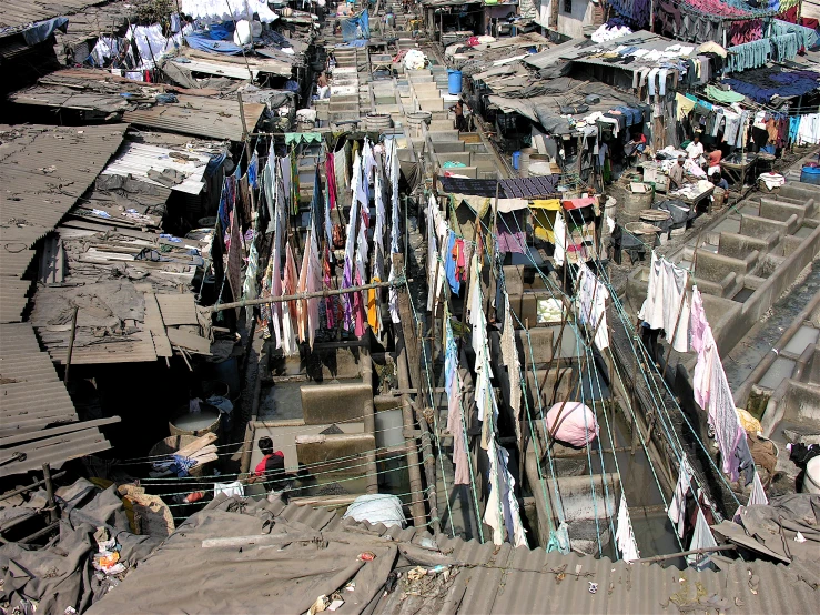 this is an aerial view of a slum that has clothes hung and is shown in the foreground