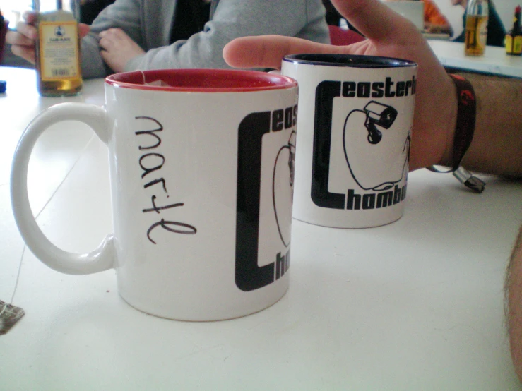 two ceramic mugs on a white table