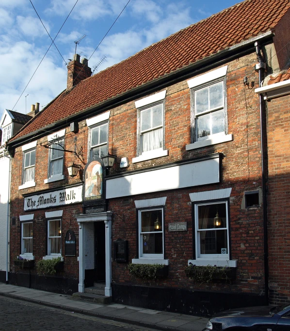 a red brick building next to a street