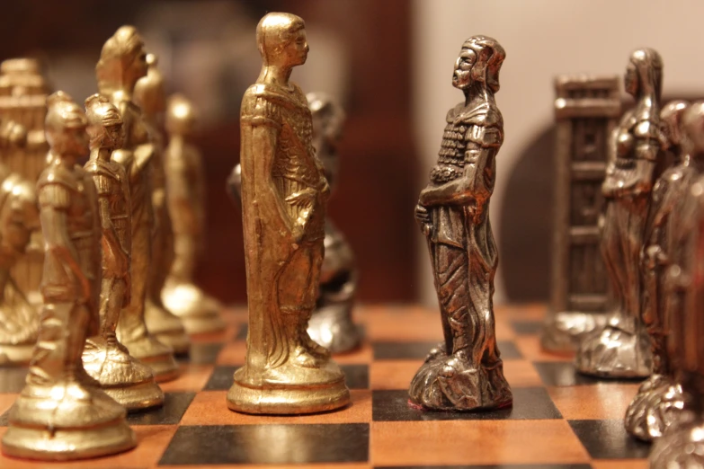 a collection of ss chess pieces on top of a wooden board