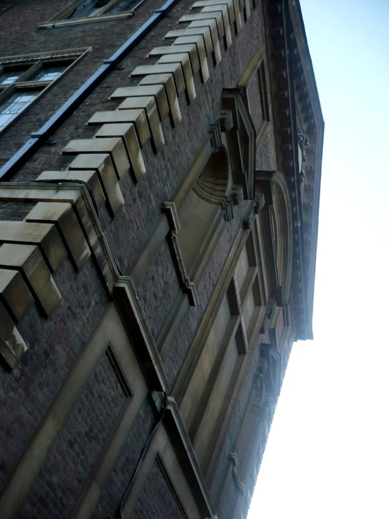 the view of a very large brick building in a city