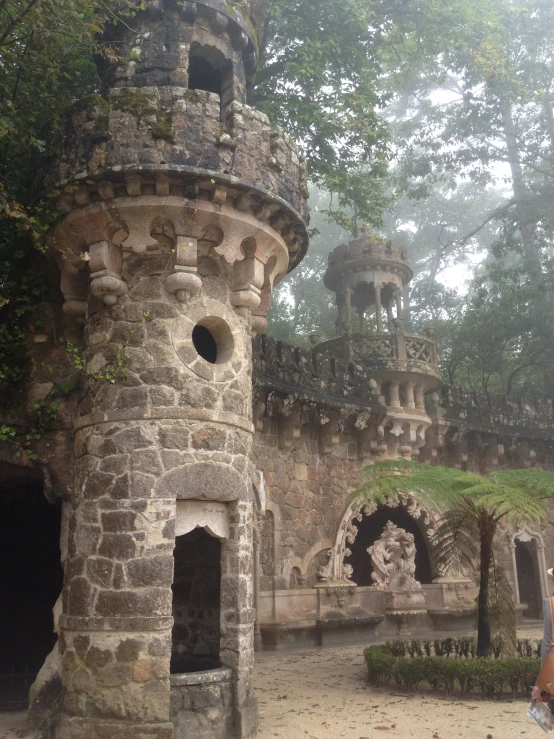 a stone building with a clock tower in front of it