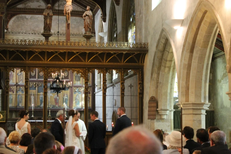 a wedding ceremony in an old church with a priest and bride