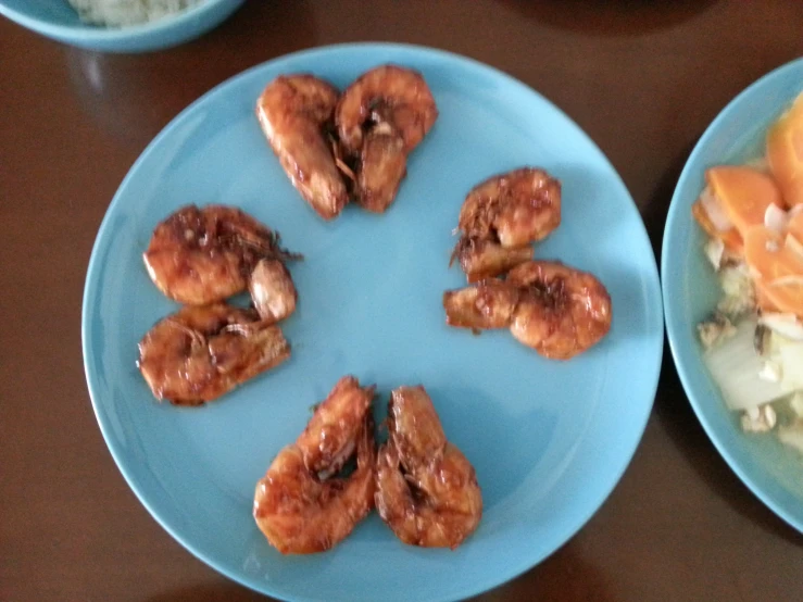 a table with three blue plates that have different types of food