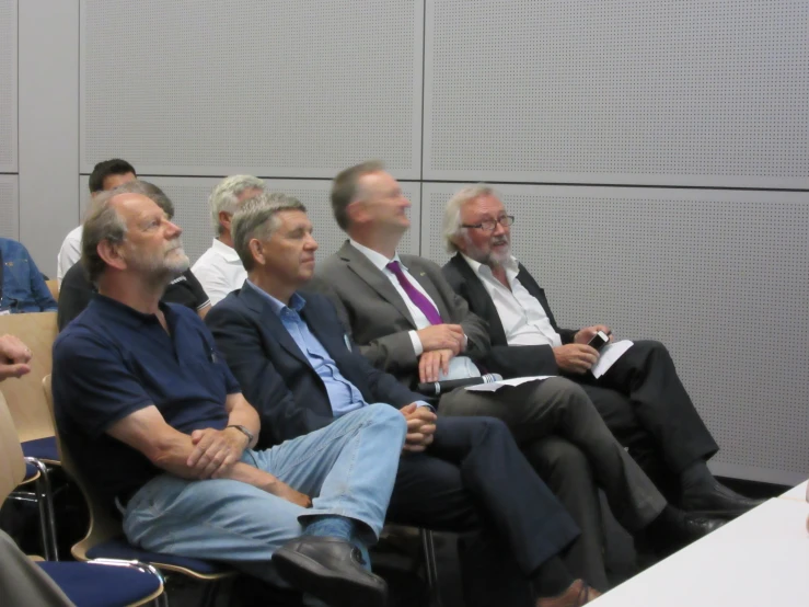 a group of men sitting next to each other