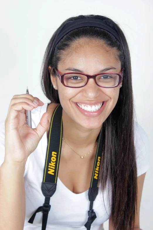 a woman in glasses with a lanyard around her neck