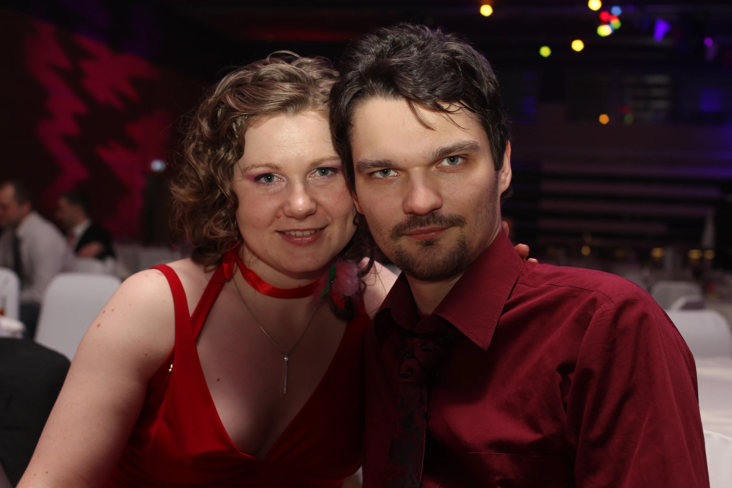 a young couple posing for a picture at a formal function