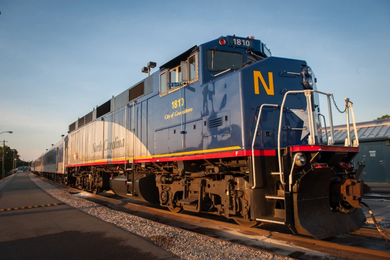 a blue train sitting on top of tracks