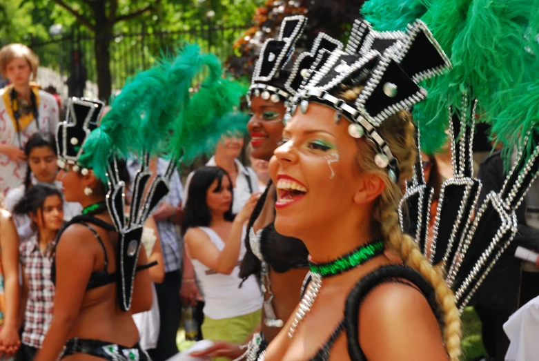 several women in costume are watching someone doing soing