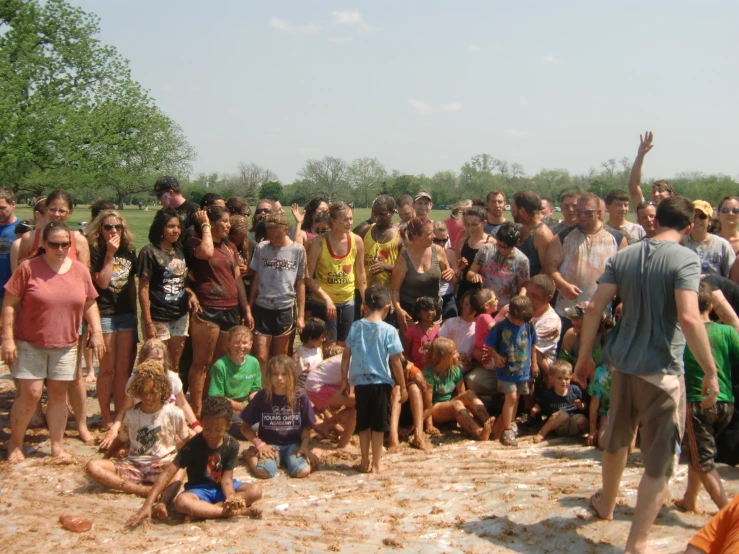 large crowd of people gather outside in the sun