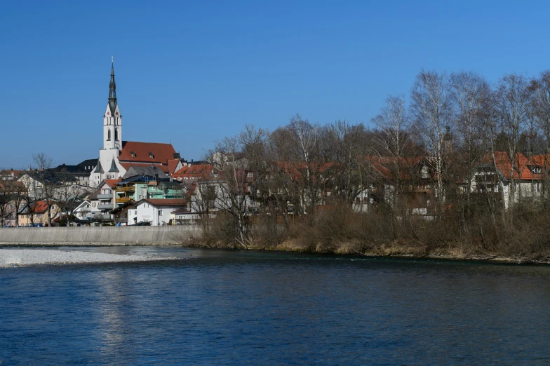 a river in front of a building and a church