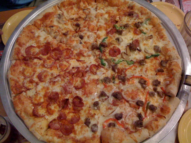 the pizza is full of cheese, sausage and other toppings