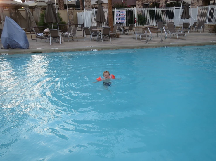 a person is playing in the water in the pool
