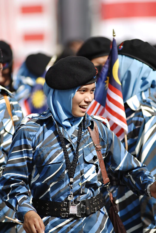 a line of young people holding flags and standing